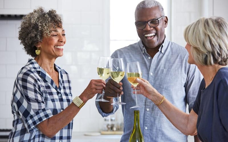 a few people toasting wine glasses