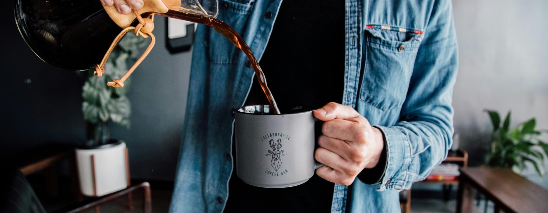 a man holding a coffee cup
