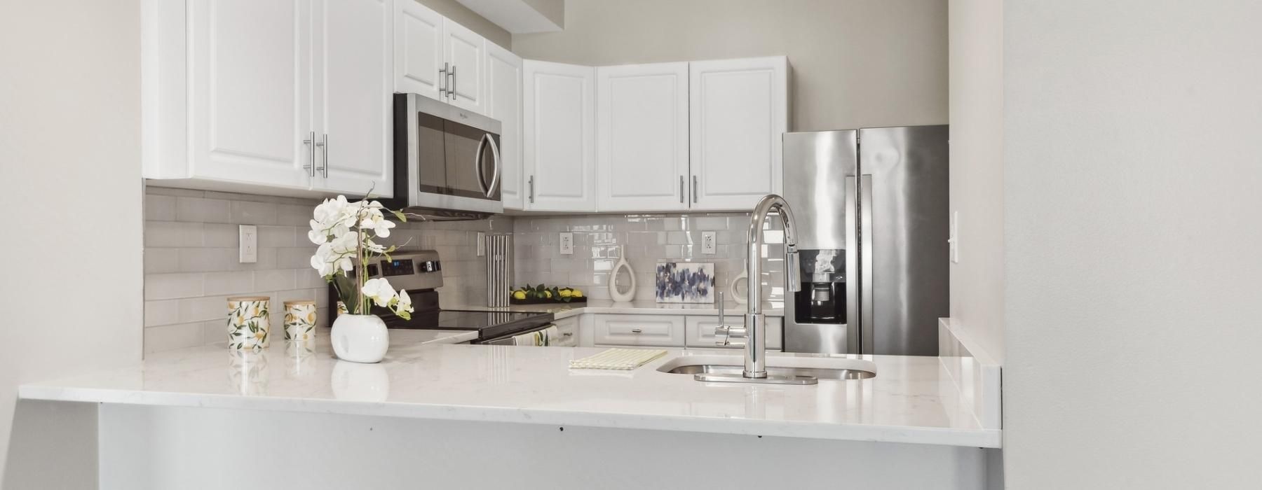 a kitchen with white cabinets