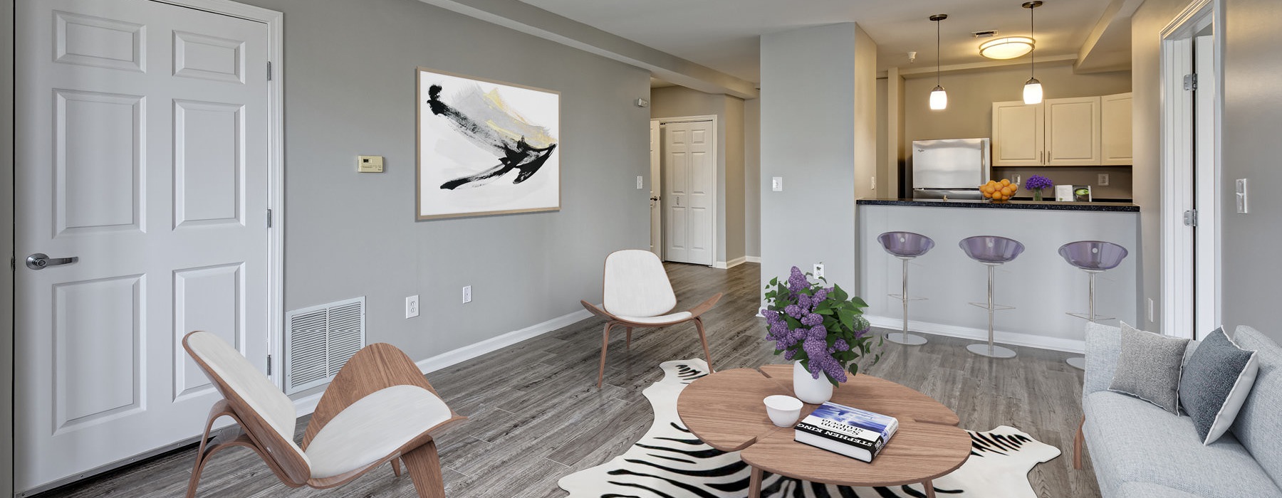 a living room with a dining table and chairs