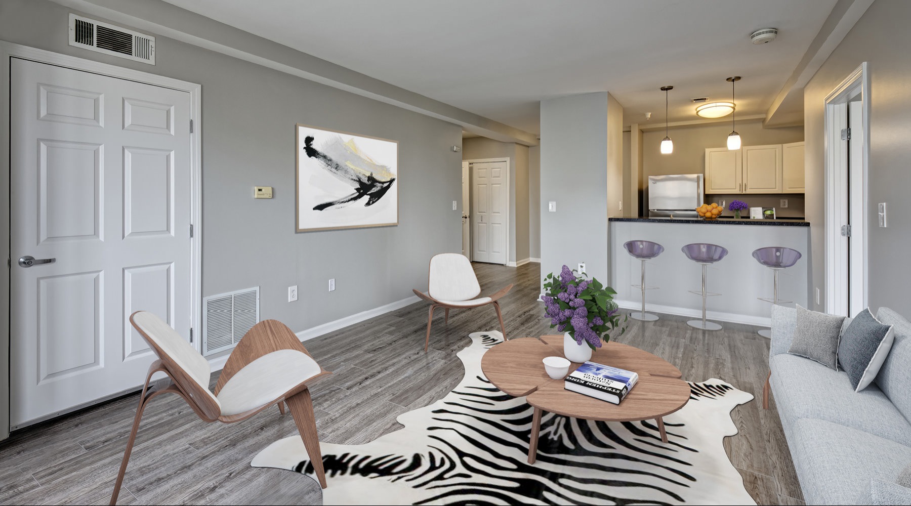 a living room with a dining table and chairs