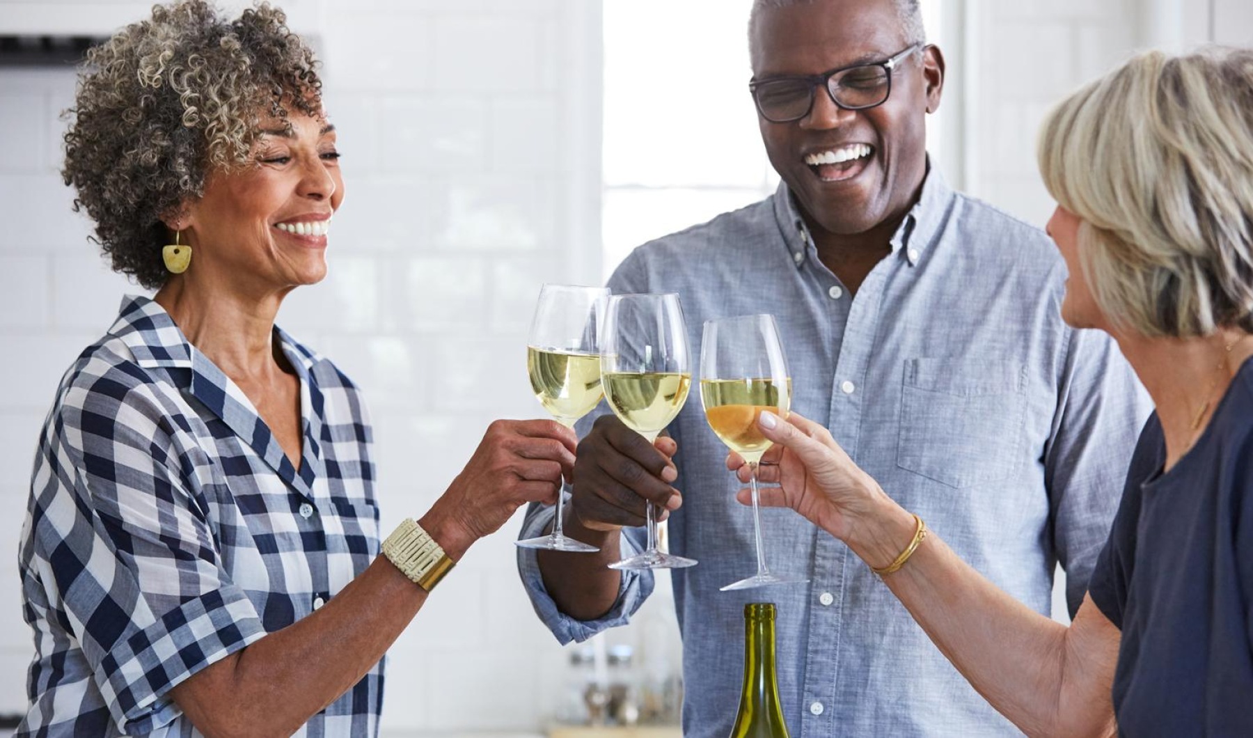 a few people toasting wine glasses